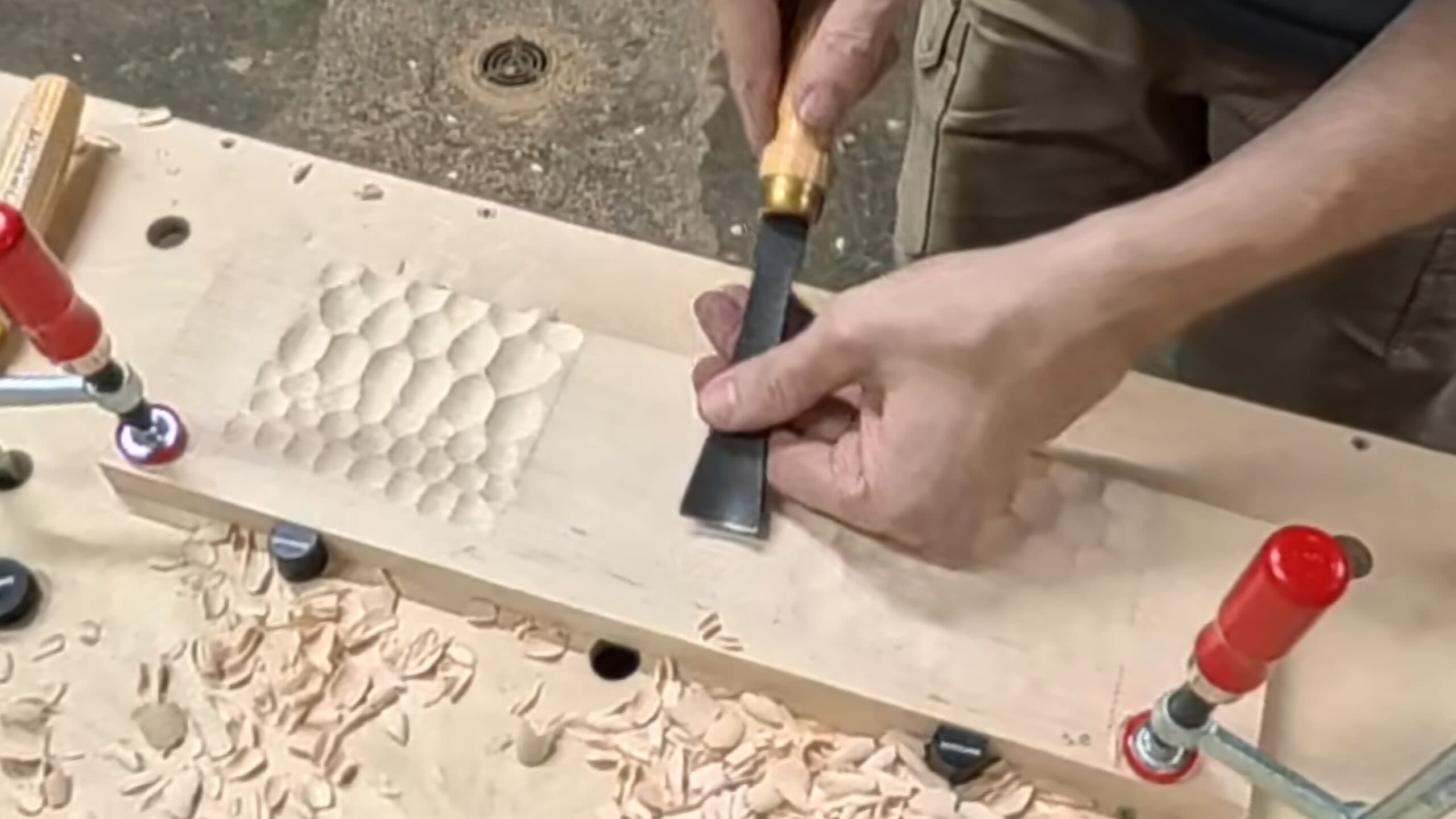Dave Newman carving Naguri texture by hand with a woodworking gouge at his shop